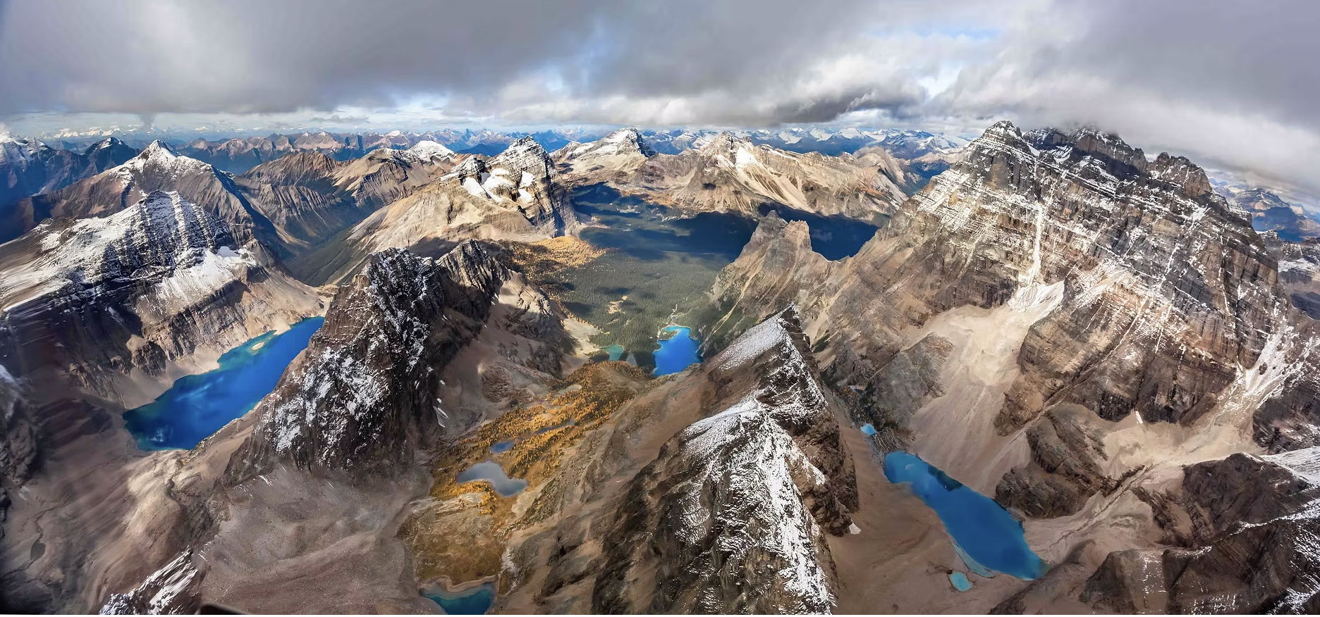 Aerial panorama of the Lake O’Hara region with turquoise glacial lakes and snow-dusted peaks
